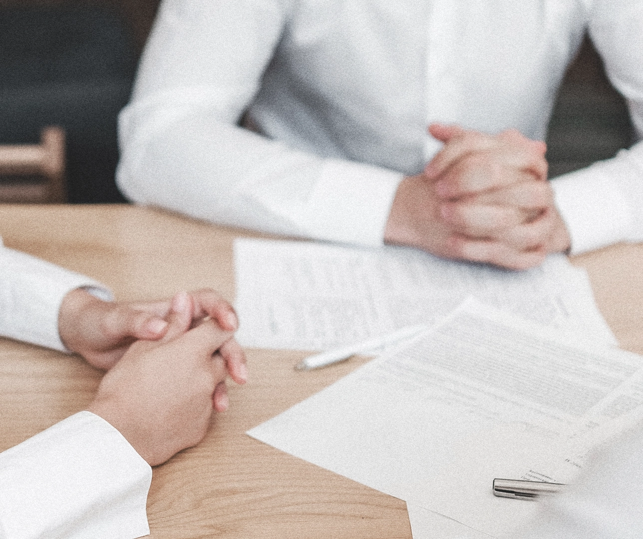 Dos personas con un contrato en medio.